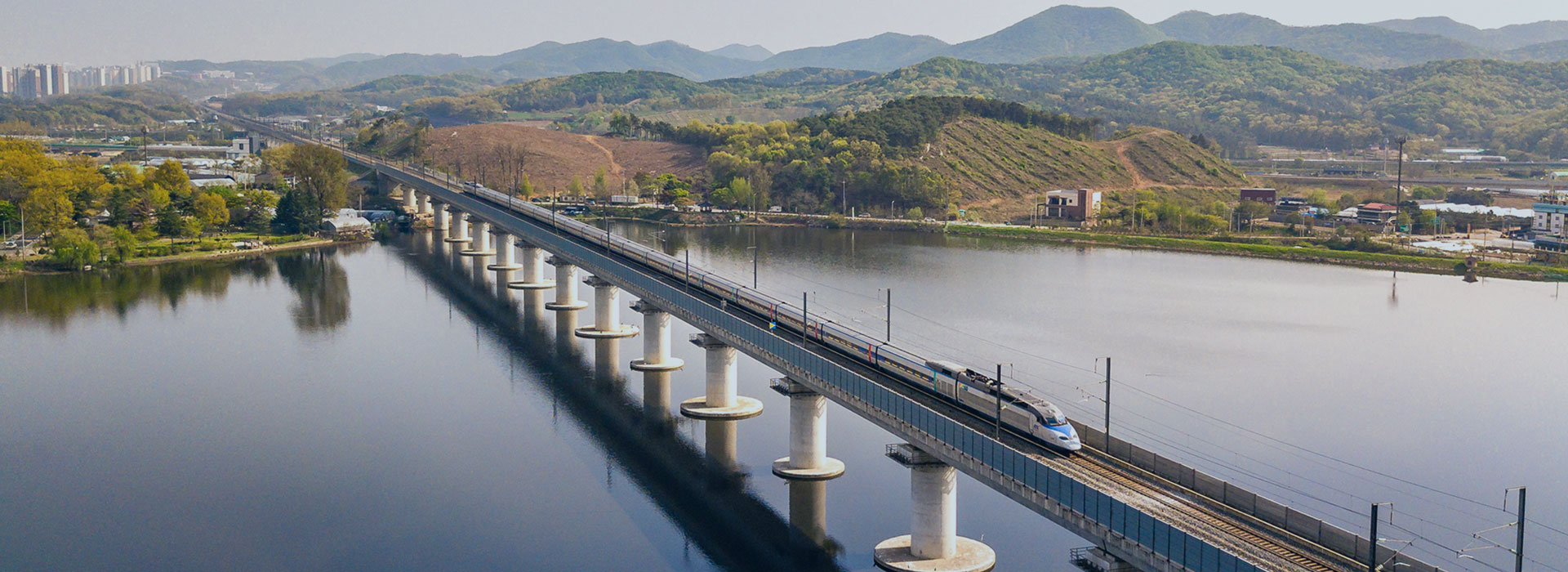 High-speed train crossing a lake bridge